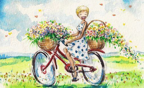 Kvinna cyklar med blommor