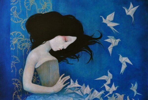 Flicka och papperstranor som faller