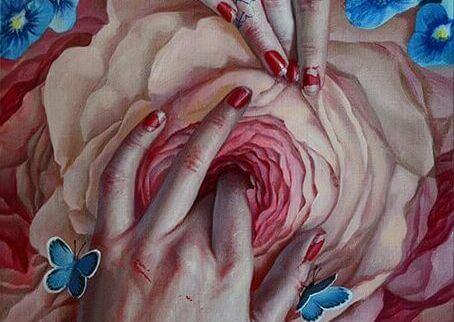 Händer berör blomma