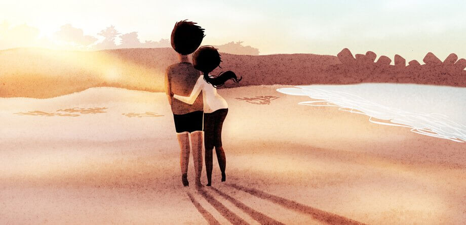 Par som njuter av friheten på stranden