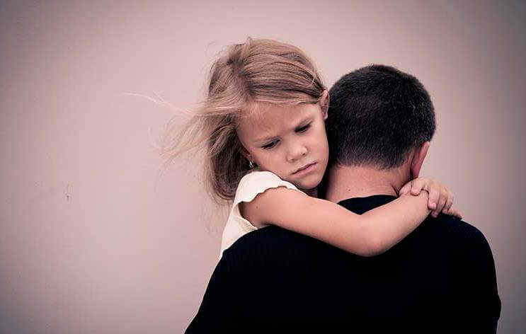 Flicka som kramar sin pappa