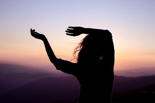 Kvinna som dansar vid soluppgången