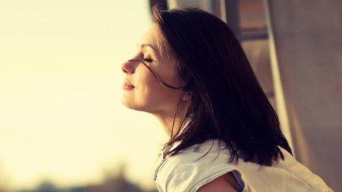 Lugn kvinna med solsken i ansiktet inser att det är dags att ändra en vana