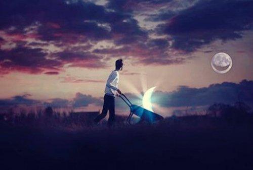 En man går med en del av månen i en skottkärra