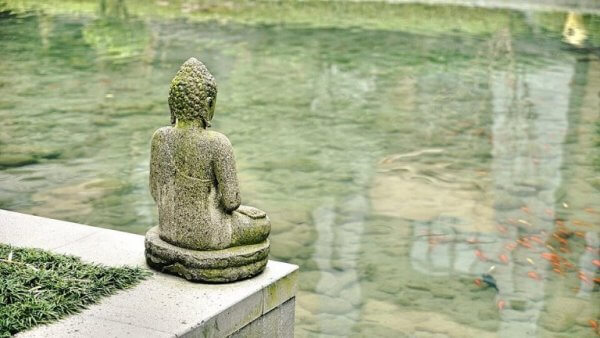 Buddhastaty vid vatten som symbol för konflikten mellan vetenskap och religion