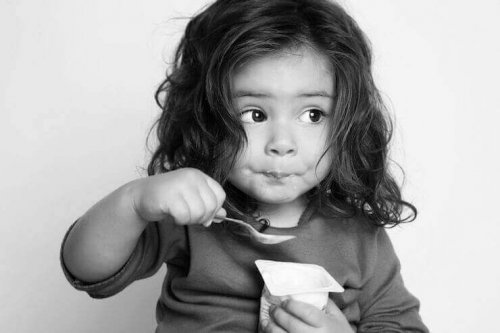 Flicka som äter yoghurt