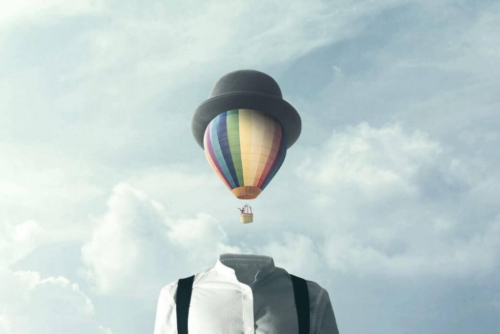 Man med luftballong som huvud