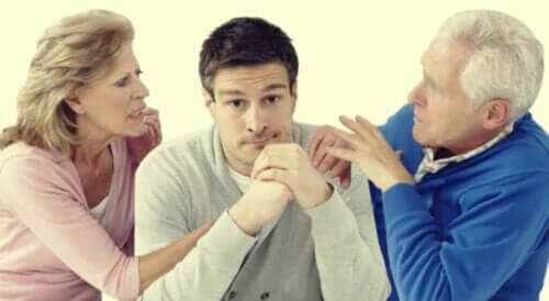 Att gå igenom sina föräldrars skilsmässa som vuxen kan vara mycket svårt. På det här fotot en vuxen son mellan sin mor och far