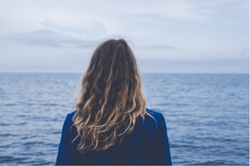 En kvinna som tittar ut över havet.